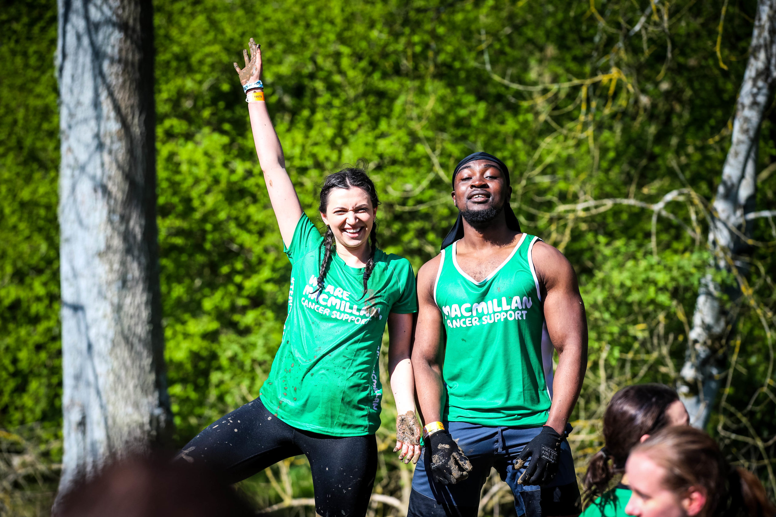 Two participants posing for a picture, the other one is raising her hand