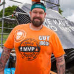 Man in an orange top smiling