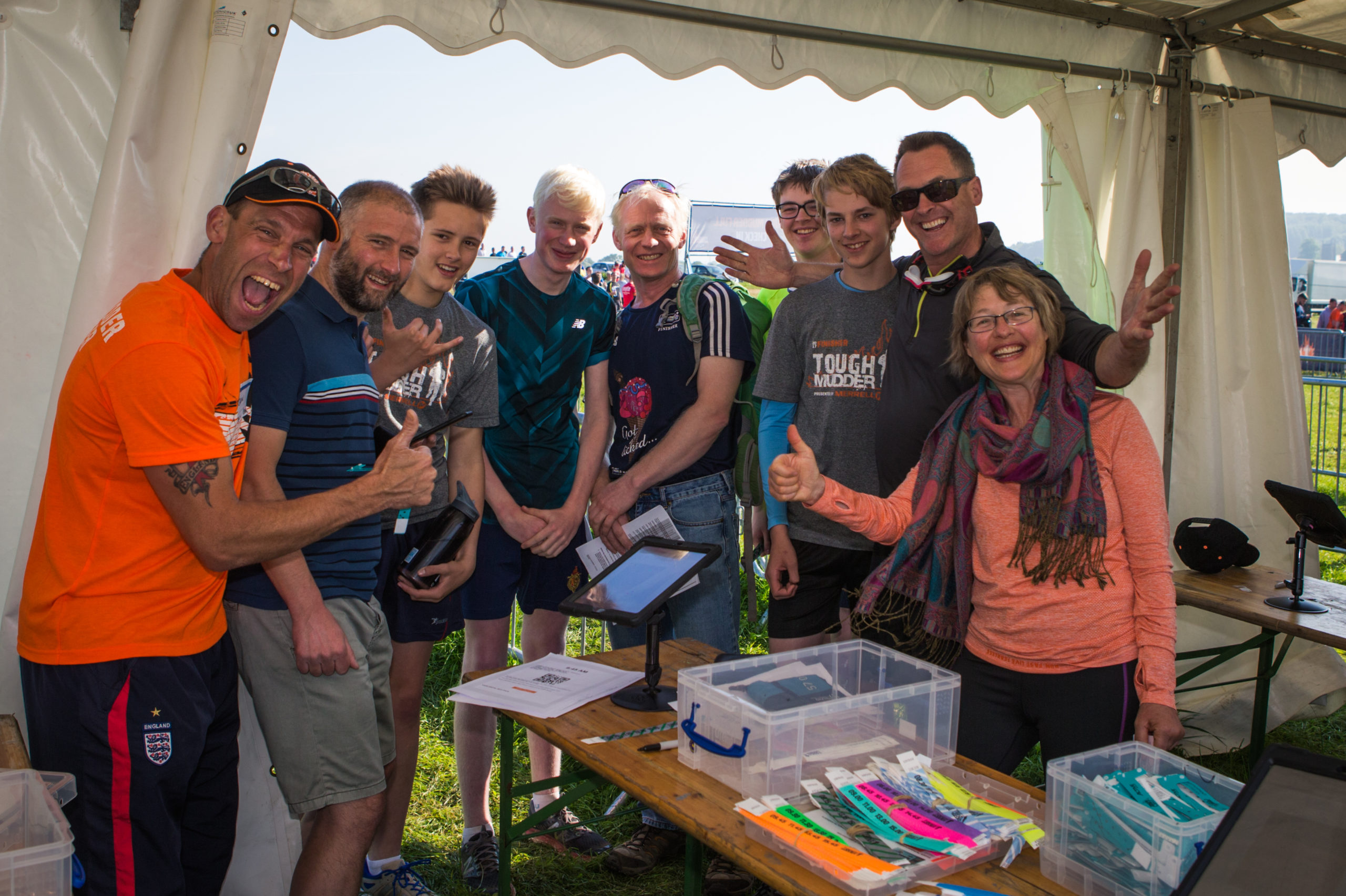 A group of people smiling and giving thumbs up