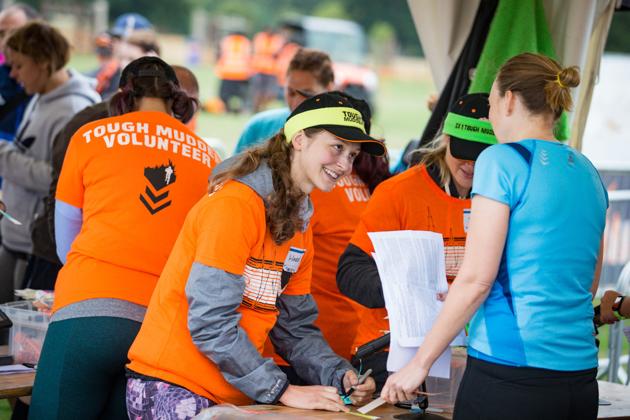 Girl in orange top smiling to a participant