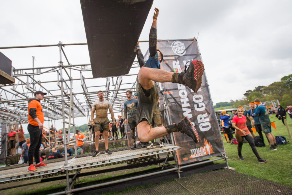 A man swinging from an obstacle
