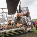 A man swinging from an obstacle