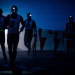 Participants running at night with flashlights on