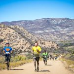 Participants running in the mountainside
