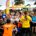 Volunteer stands in front of kid participants