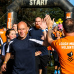 Volunteer high fiving runners