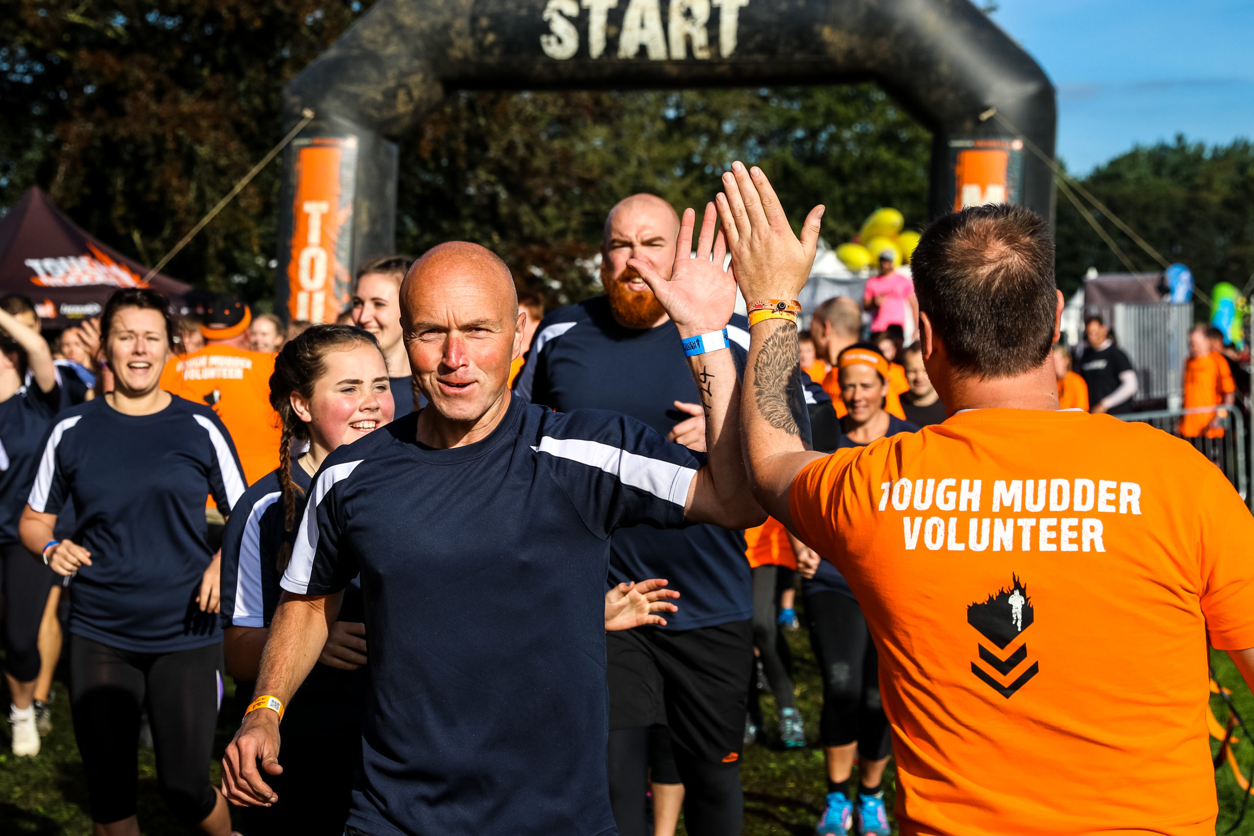 Volunteer high fiving runners