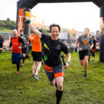 Participant holding a smoke bomb as he ran from the starting line
