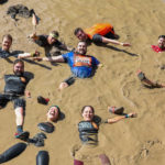 group people in Tough Mudder mud