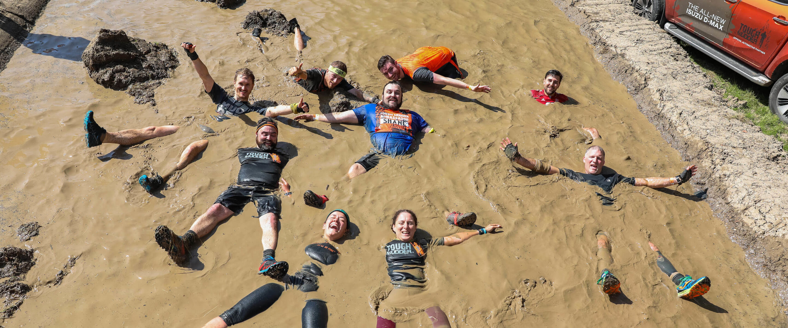 group people in Tough Mudder mud