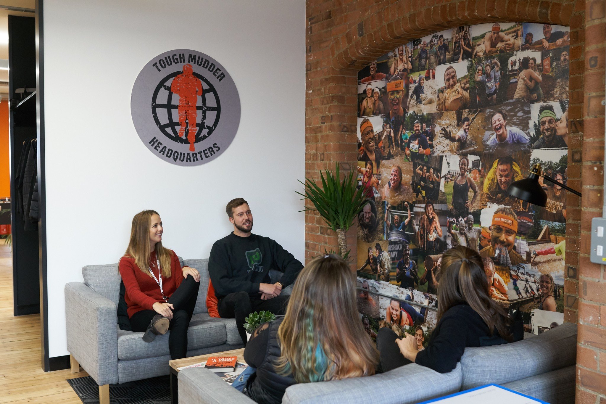 People chatting in Tough Mudder Headquarters